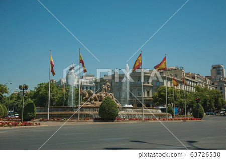 Street and Cybele fountain with Spanish flags in Madrid Street and Cybele fountain with Spanish flags in Madrid 63726530