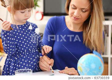 Blond smiling little girl hold in arm brush 63730339