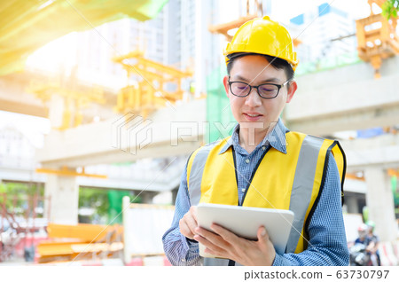 Young asian engineers are working on the construction site 63730797