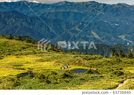 Hikers and mountains in the direction of Mt. Hikers and mountains in the direction of Mt. 63730840