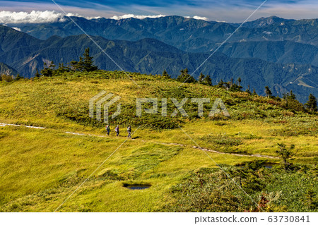A climber who goes through the moor of the mountain ridge line A climber who goes through the moor of the mountain ridge line 63730841
