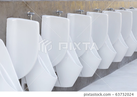 White urinals on wall in public toilet White urinals on wall in public toilet 63732024