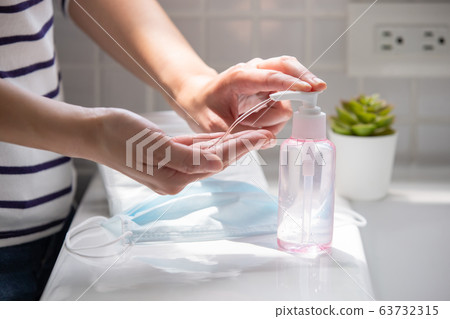 woman use hand sanitizer gel woman use hand sanitizer gel 63732315