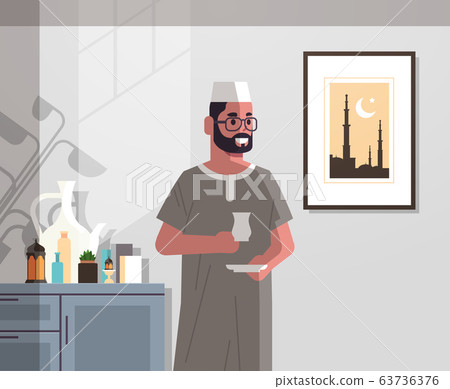 arabic man in traditional clothes drinking coffee celebrating ramadan kareem holy month modern living room interior flat vertical portrait 63736376