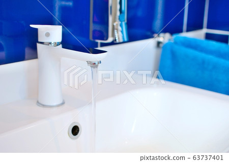 Sink faucet with flowing water closeup Sink faucet with flowing water closeup 63737401