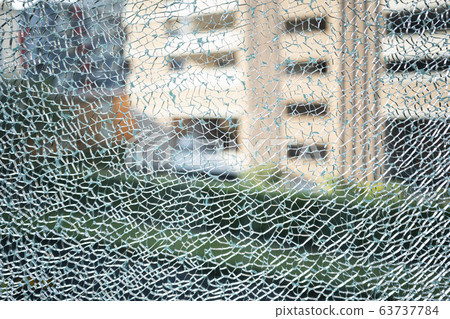 A cracked of blue green tempered glass 63737784