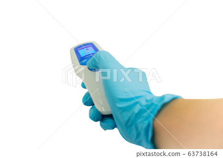 Closeup hand in a blue glove holds an digital infrared thermometer Isolated. Closeup hand in a blue glove holds an digital infrared thermometer Isolated. 63738164