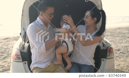 Holiday concept. Parents raise babies by the 63740349