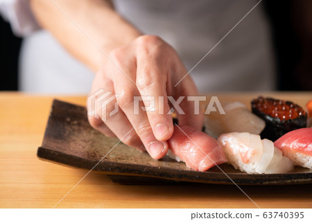 In front of the board holding the bag 63740395