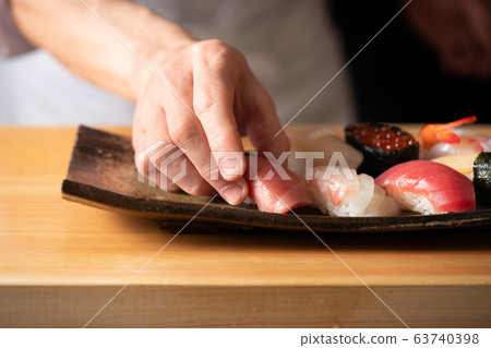 In front of the board holding the bag 63740398