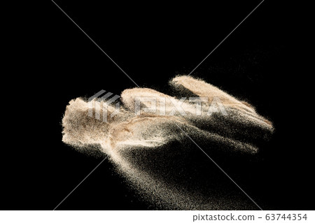 Brown colored sand splash.Dry river sand explosion isolated on black background. Abstract sand cloud. Brown colored sand splash.Dry river sand explosion isolated on black background. Abstract sand cloud. 63744354
