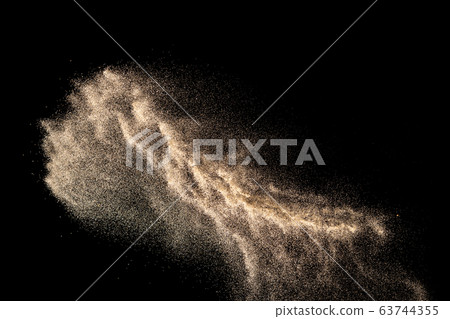 Brown colored sand splash.Dry river sand explosion isolated on black background. Abstract sand cloud. Brown colored sand splash.Dry river sand explosion isolated on black background. Abstract sand cloud. 63744355