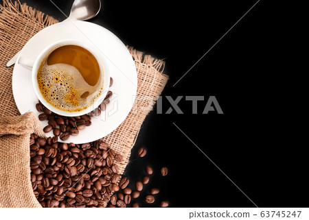 Coffee beans in a bag and a cup with coffee. Top Coffee beans in a bag and a cup with coffee. Top 63745247