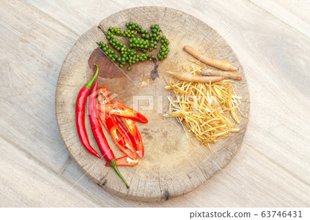 Top view picture of chili, fingerroot, and pepper on the wooden plate Top view picture of chili, fingerroot, and pepper on the wooden plate 63746431