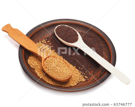 Mustard seeds black and white in a plate isolated on white Mustard seeds black and white in a plate isolated on white 63746777
