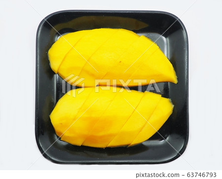 Ripe mangoes sliced in a black plate isolated on white background. Ripe mangoes sliced in a black plate isolated on white background. 63746793