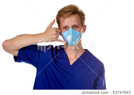 Portrait of a charming medical doctor gesturing call me with his Portrait of a charming medical doctor gesturing call me with his 63747945