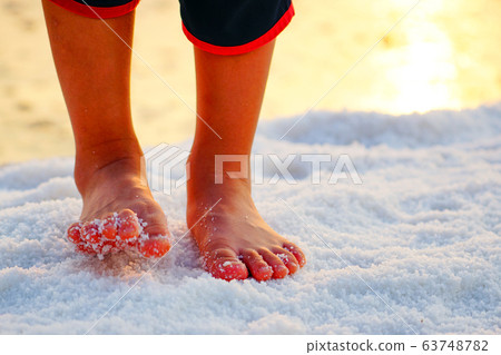 A child walking barefoot in a salt field at the salt-filled experience in Sorae Wetland Ecological Park, Incheon A child walking barefoot in a salt field at the salt-filled experience in Sorae Wetland Ecological Park, Incheon 63748782