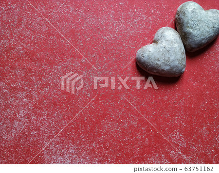 Red dusty background with heart shaped biscuits and text space for valentine's day Red dusty background with heart shaped biscuits and text space for valentine's day 63751162