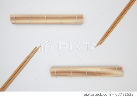 Bamboo mat with chopsticks for sushi on the white Bamboo mat with chopsticks for sushi on the white 63751522