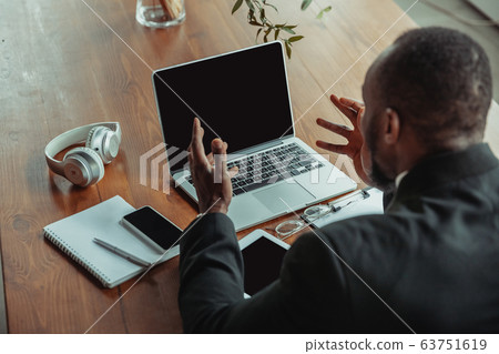 Businessman or student working from home while being isolated or keep quarantine 'cause of coronavirus COVID-19 63751619