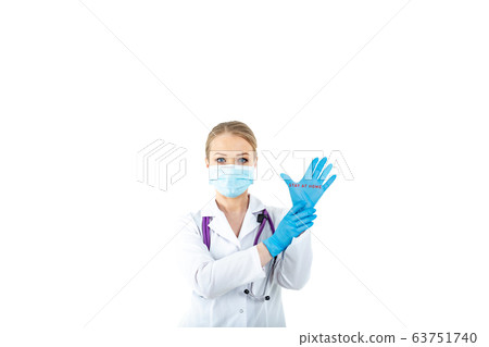 A young female doctor with protective latex gloves against coronavirus with a message to stay home 63751740