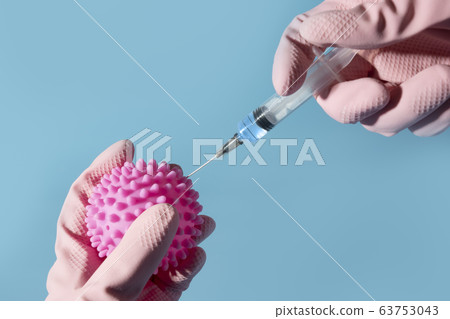 Hands of scientist in gloves with syringe inject 63753043