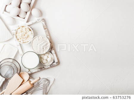 Fresh dairy products on white table background. Fresh dairy products on white table background. 63753276