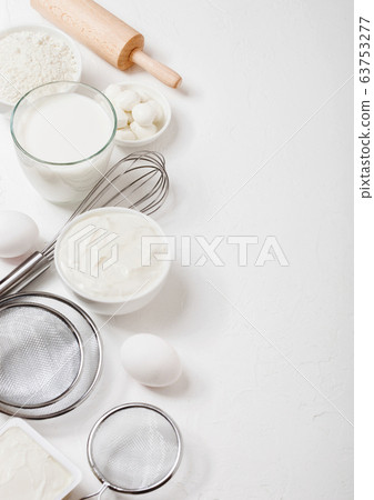 Fresh dairy products on white table background. Fresh dairy products on white table background. 63753277