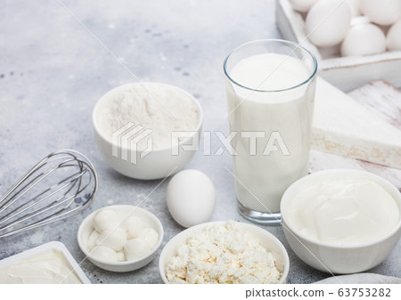 Fresh dairy products on white table background. Fresh dairy products on white table background. 63753282