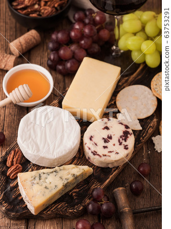 Selection of various cheese on the board and Selection of various cheese on the board and 63753291