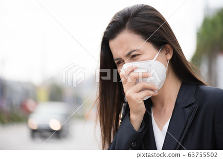 Close up of a businesswoman in a suit wearing 63755502