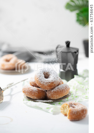 Donuts with sugar powder on the white background Donuts with sugar powder on the white background 63756645