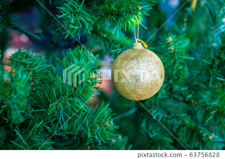 Gold Christmas ball hanging on pine branches party festive 63756828
