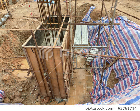 Pile cap and column stump under construction at the construction site. Constructed using reinforced concrete with plywood timber as a form work. 63761784