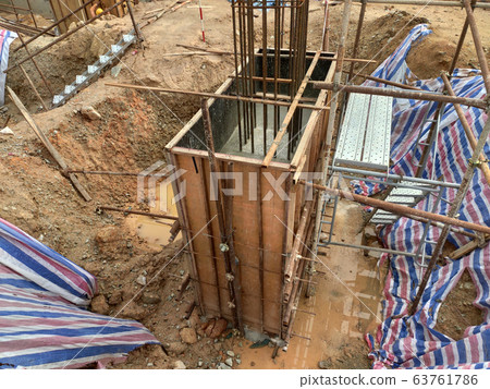 Pile cap and column stump under construction at the construction site. Constructed using reinforced concrete with plywood timber as a form work. 63761786
