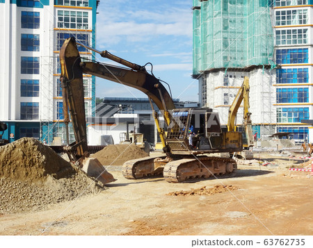 Excavators machine at the construction site. It is used to excavate soil and lifting material at the construction site. Powered by the hydraulic arm with a bucket.   63762735