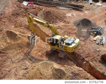 Excavators machine at the construction site. It is used to excavate soil and lifting material at the construction site. Powered by the hydraulic arm with a bucket. Excavators machine at the construction site. It is used to excavate soil and lifting material at the construction site. Powered by the hydraulic arm with a bucket. 63762736