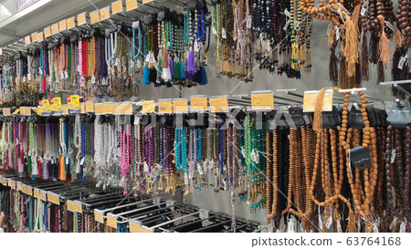 Various type of prayer beads hung for sale inside the supermarkets. It is made from various materials such as plastic and wood. Various type of prayer beads hung for sale inside the supermarkets. It is made from various materials such as plastic and wood. 63764168