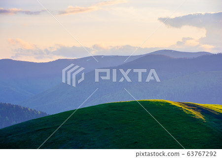 mountainous countryside in springtime at dusk. mountainous countryside in springtime at dusk. 63767292