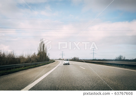 classic Fiat 500 driving on street on sunny day classic Fiat 500 driving on street on sunny day 63767608