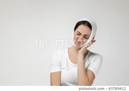 young sad woman suffering from tooth pain young sad woman suffering from tooth pain 63769422