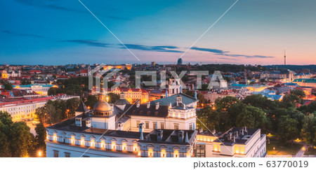 Vilnius, Lithuania, Eastern Europe. Night Panoramic View Of Historic Center Cityscape In Blue Hour. Travel View Of Old Town In Night Illuminations. UNESCO. Palace Of The Grand Dukes Of Lithuania. Vilnius, Lithuania, Eastern Europe. Night Panoramic View Of Historic Center Cityscape In Blue Hour. Travel View Of Old Town In Night Illuminations. UNESCO. Palace Of The Grand Dukes Of Lithuania. 63770019