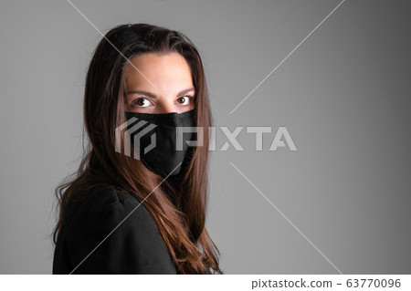 Young woman wearing black protective mask. Flu or virus pandemic. Allergy season Young woman wearing black protective mask. Flu or virus pandemic. Allergy season 63770096