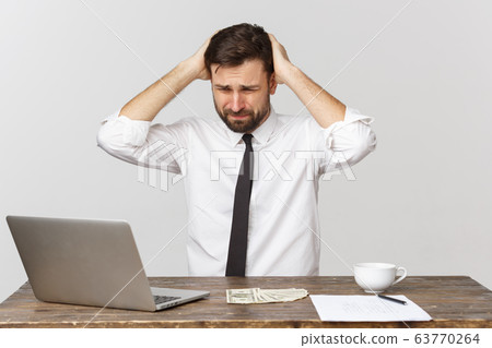 unhappy male working in the office, looking at the camera, front view, isolated on white. unhappy male working in the office, looking at the camera, front view, isolated on white. 63770264