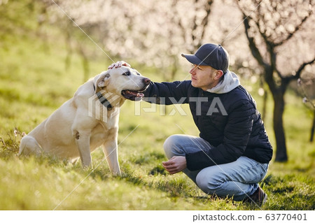 Man with dog in spring nature 63770401