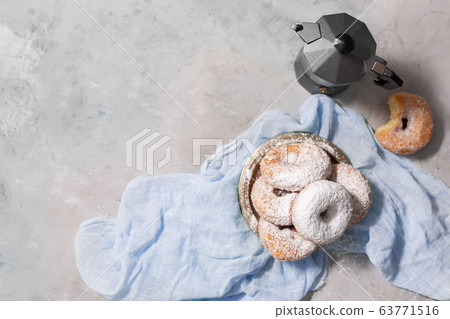 Donuts with sugar powder on gray background Donuts with sugar powder on gray background 63771516