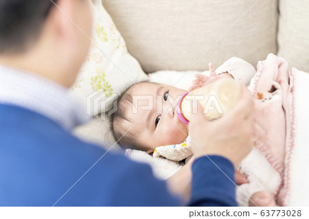 Father nursing a 7 month old daughter 63773028