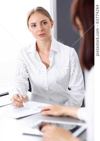 Group of business people or lawyers discussing terms of transaction in office. Colleagues working all together. Meeting concept Group of business people or lawyers discussing terms of transaction in office. Colleagues working all together. Meeting concept 63774264