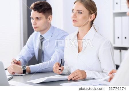 Group of business people or lawyers discussing terms of transaction in office. Colleagues working all together. Meeting concept Group of business people or lawyers discussing terms of transaction in office. Colleagues working all together. Meeting concept 63774274